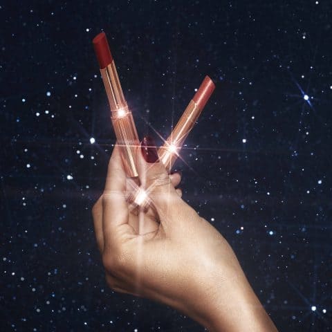 hand holding charlotte tilbury lipsticks